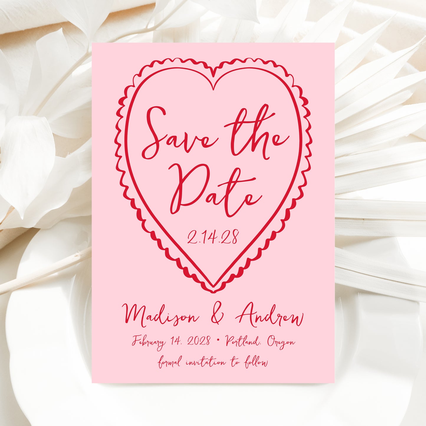 Pink 'Save the Date' card with red text on a white floral background
